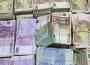 Bundles of confiscated money are displayed at a police headquarter in Madrid