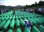 A Bosnian woman mourns over the cofin of